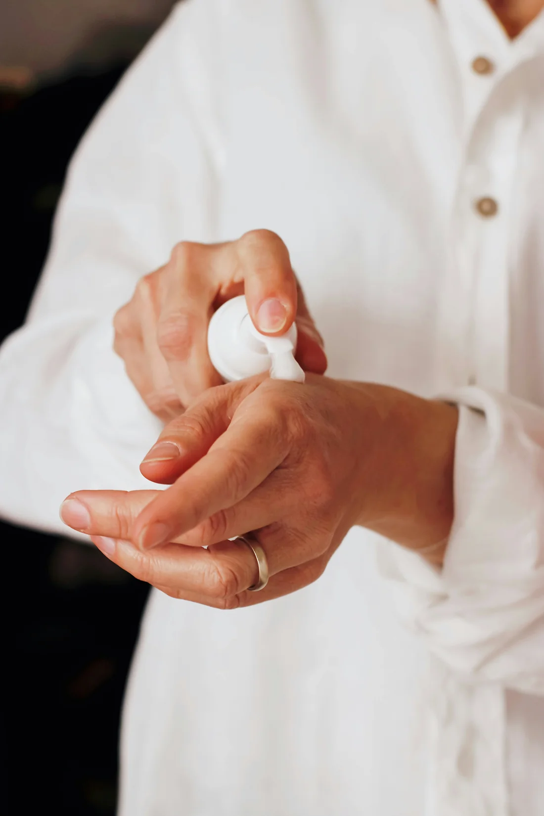 Photograph of cream being dispensed onto a hand
