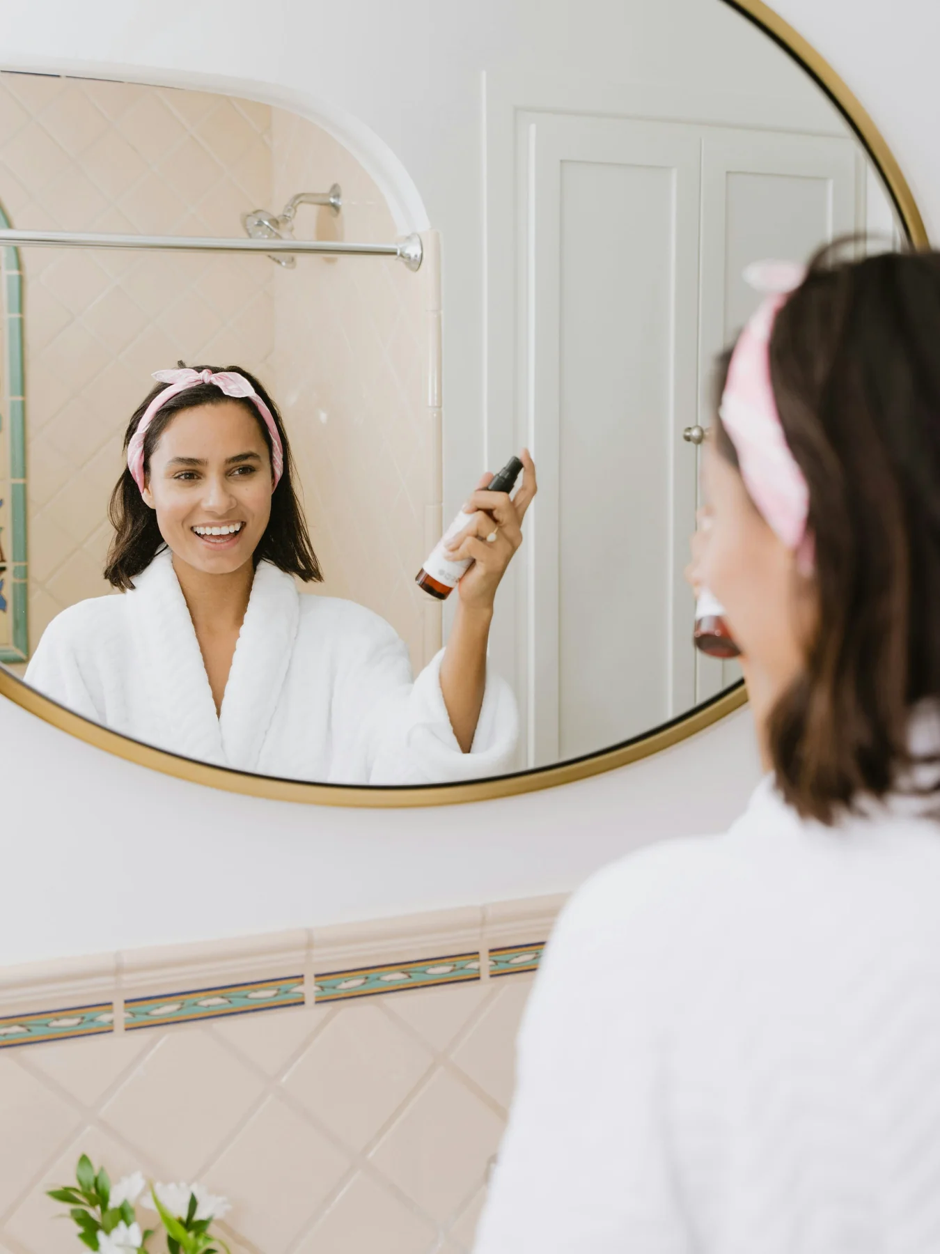 Photograph of a woman caring for her skin at a mirror